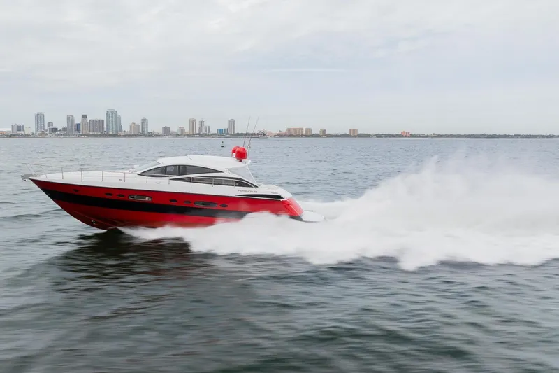 Slide: The Image of 2007 Pershing 56 yacht speeding on water with city skyline in background. - 42