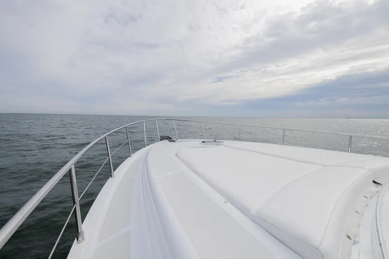 Slide: The Image of Bow view of 2007 Pershing 56 yacht cruising on open sea under cloudy sky. - 43