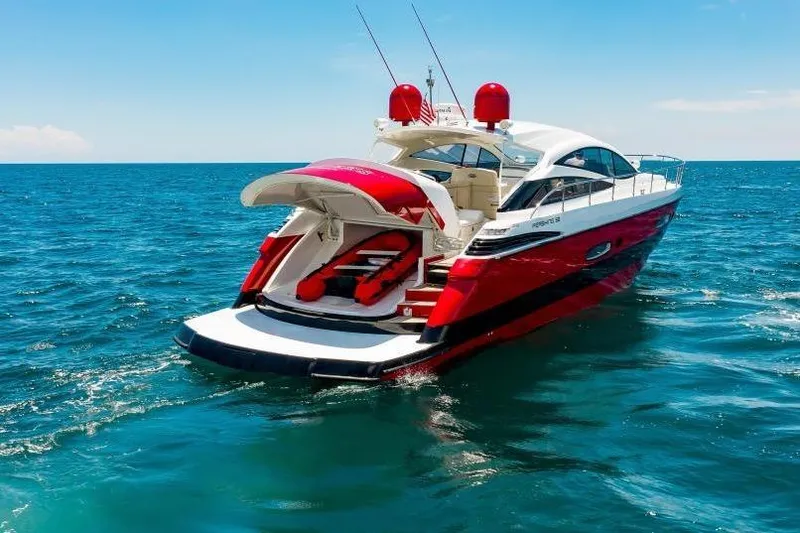 Slide: The Image of Luxury 2007 Pershing 56 yacht cruising on open sea, featuring sleek red and white design. - 5