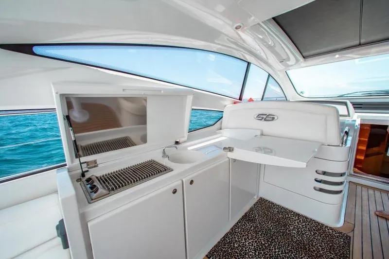 Slide: The Image of Luxurious 2007 Pershing 56 yacht interior with kitchenette and ocean view. - 9