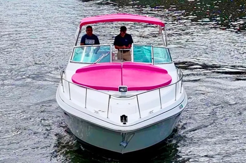 Slide: The Image of 2001 Sea Ray 340 Sundancer boat with pink accents cruising on water. - 10
