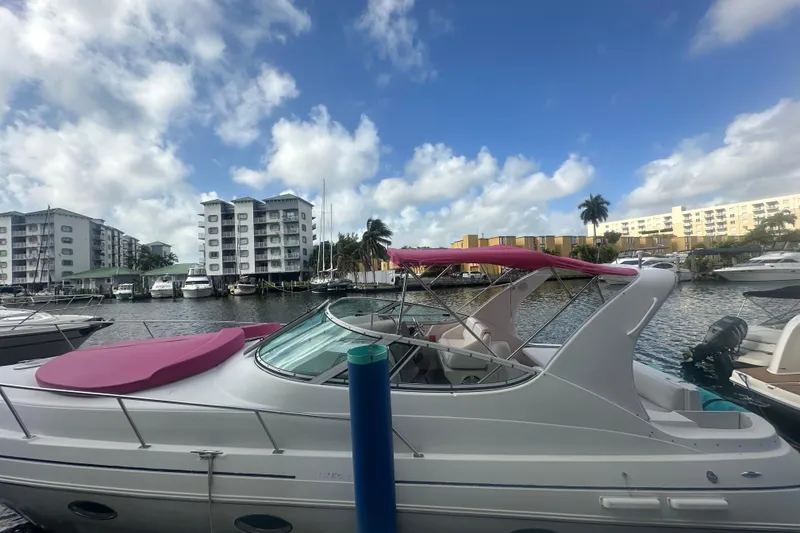 Slide: The Image of 2001 Sea Ray 340 Sundancer docked at marina with buildings and palm trees in background. - 21