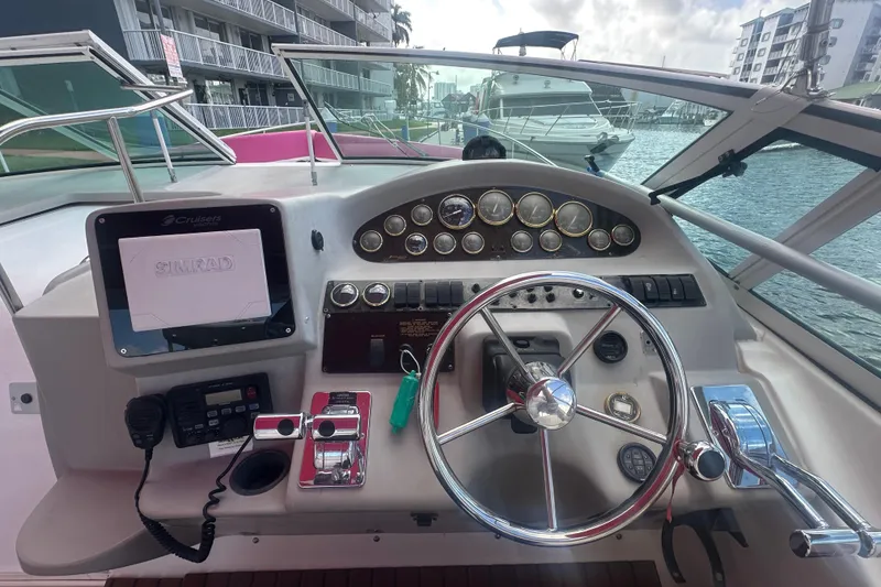 Slide: The Image of Cockpit of 2001 Sea Ray 340 Sundancer with steering wheel and navigation instruments. - 24