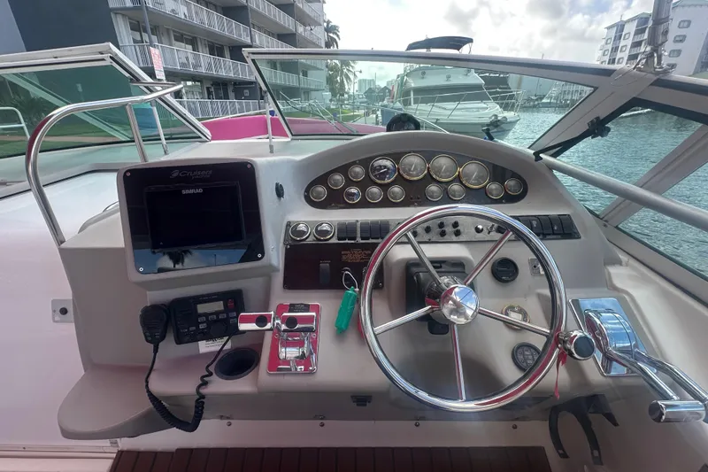 Slide: The Image of Cockpit view of 2001 Sea Ray 340 Sundancer with steering wheel and control panel. - 25