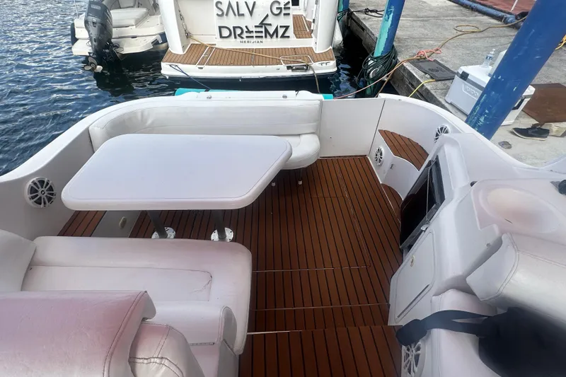 Slide: The Image of 2001 Sea Ray 340 Sundancer boat interior with seating and table, docked at marina. - 32