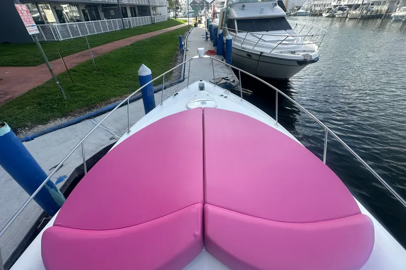 Slide: The Image of 2001 Sea Ray 340 Sundancer with pink deck cushions docked at marina. - 33
