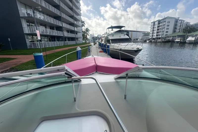 Slide: The Image of 2001 Sea Ray 340 Sundancer docked near waterfront buildings under a cloudy sky. - 34