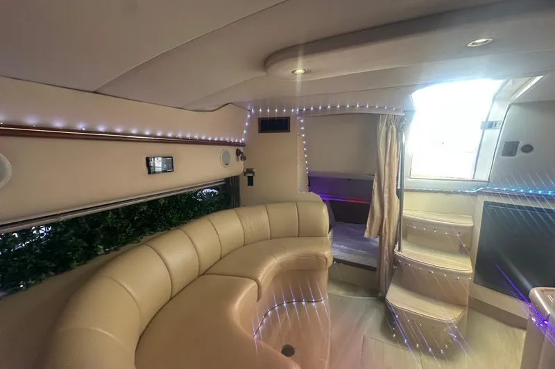Slide: The Image of Luxurious interior of a 2001 Sea Ray 340 Sundancer yacht with elegant seating and ambient lighting. - 38