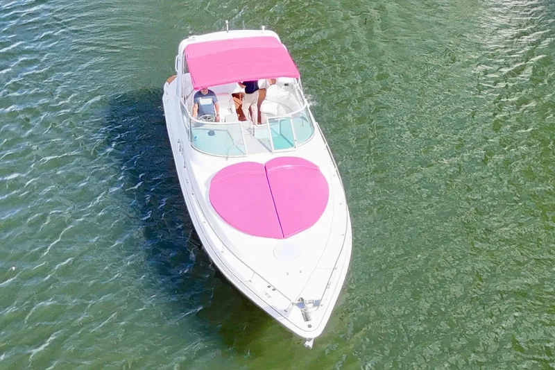Slide: The Image of 2001 Sea Ray 340 Sundancer with pink sunshade on water. - 4