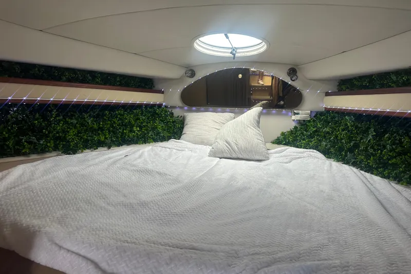 Slide: The Image of Luxurious cabin interior of 2001 Sea Ray 340 Sundancer with cozy bedding and ambient lighting. - 48