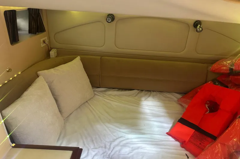 Slide: The Image of Cozy cabin interior of 2001 Sea Ray 340 Sundancer with cushions and life jackets. - 49