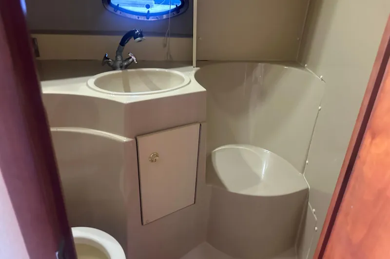 Slide: The Image of Bathroom interior of 2001 Sea Ray 340 Sundancer yacht, featuring sink and toilet. - 50