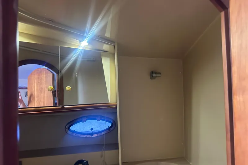 Slide: The Image of Interior of 2001 Sea Ray 340 Sundancer boat bathroom with mirror and porthole. - 51