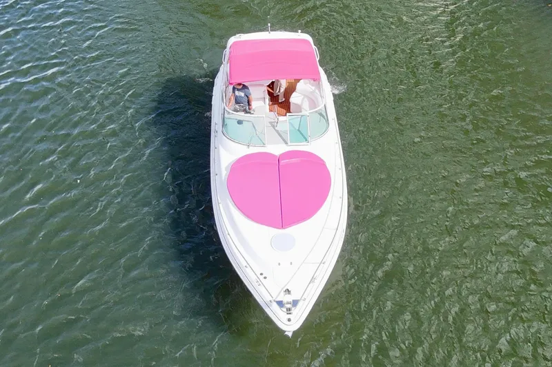 Slide: The Image of 2001 Sea Ray 340 Sundancer with pink canopy cruising on water. - 7