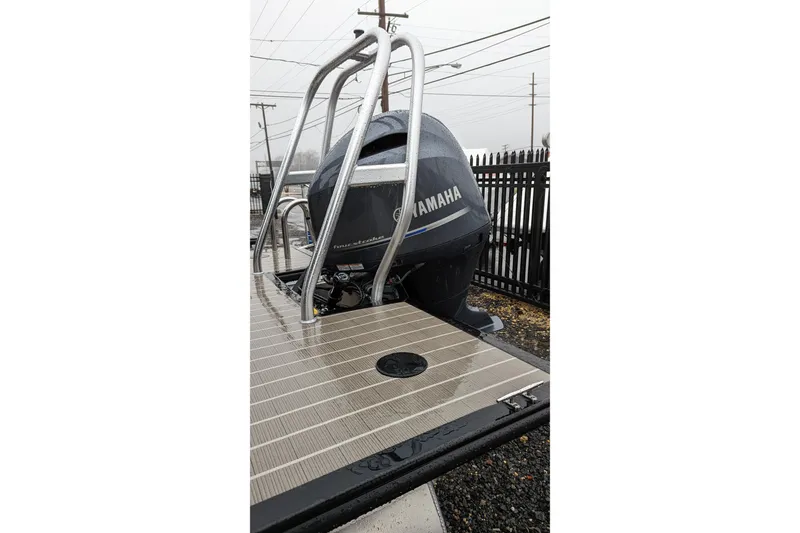 Slide: The Image of 2022 Bentley Pontoons 240 Navigator with Yamaha outboard motor on a rainy day. - 2