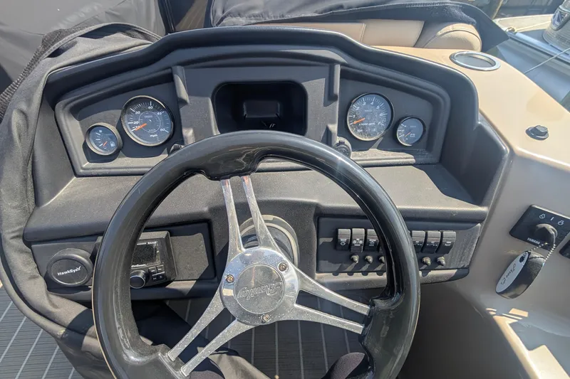 Slide: The Image of 2022 Bentley Pontoons 240 Navigator dashboard with steering wheel and gauges. - 7