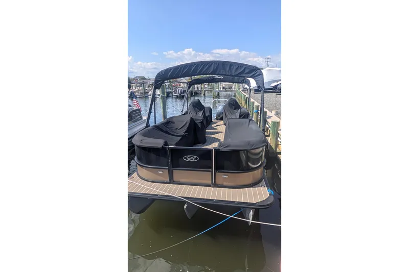 Slide: The Image of 2022 Bentley Pontoons 240 Navigator docked, covered, with a canopy, on a sunny day. - 8