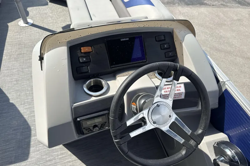 Slide: The Image of Steering console of 2023 Bennington 25ssrc boat with modern controls and display. - 11