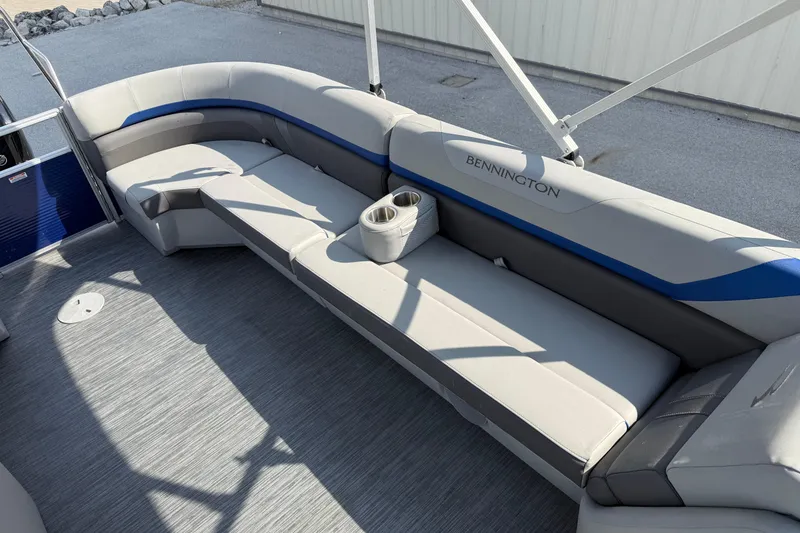 Slide: The Image of 2023 Bennington 25ssrc pontoon boat interior with gray seating and cup holder. - 15