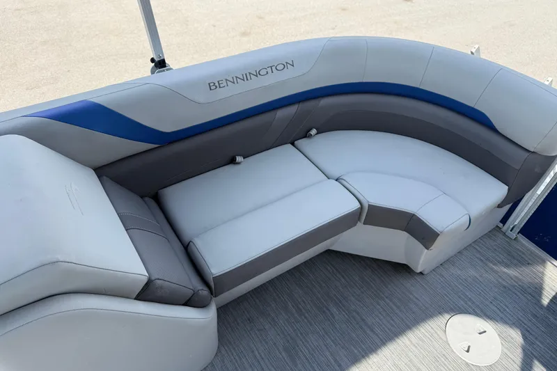 Slide: The Image of 2023 Bennington 25ssrc boat interior with curved seating and modern upholstery. - 16