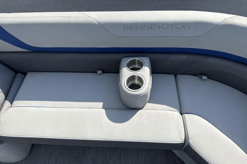 Slide: The Image of 2023 Bennington 25ssrc boat seating with integrated cup holders, featuring sleek gray upholstery. - 8
