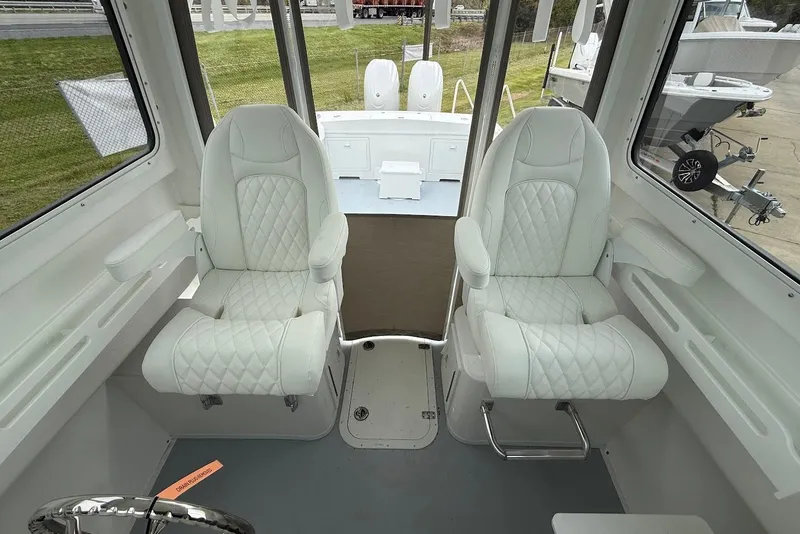 Slide: The Image of Interior of 2026 Steiger Craft 255 Miami boat with two white cushioned seats. - 11