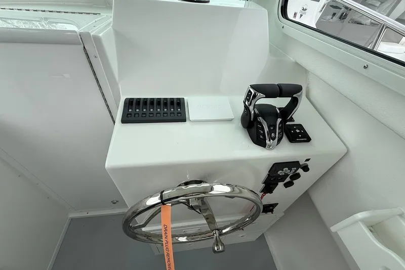 Slide: The Image of Steiger Craft 255 Miami 2026 helm with steering wheel and controls. - 12