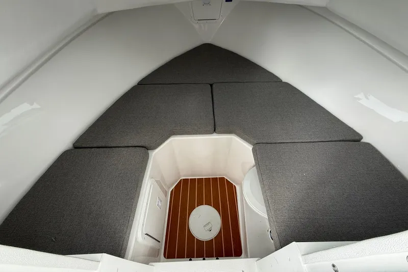 Slide: The Image of 2026 Steiger Craft 255 Miami cabin interior with cushioned seating and wooden flooring. - 14