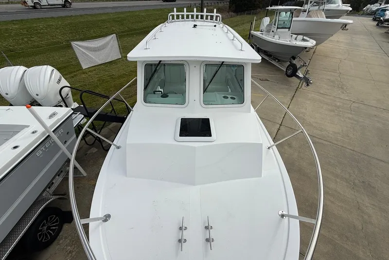 Slide: The Image of 2026 Steiger Craft 255 Miami boat on display at a marina. - 18