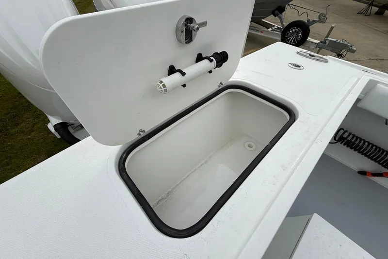 Slide: The Image of 2026 Steiger Craft 255 Miami boat storage compartment with open lid and drainage system. - 8
