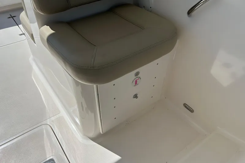 Slide: The Image of 2016 Pursuit DC 265 Dual Console boat seat and storage compartment. - 11