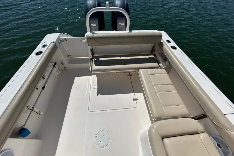 Slide: The Image of 2016 Pursuit DC 265 Dual Console boat interior with seating and twin engines. - 19
