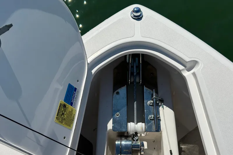 Slide: The Image of Anchor compartment of 2016 Pursuit DC 265 Dual Console boat, showing detailed hardware. - 22