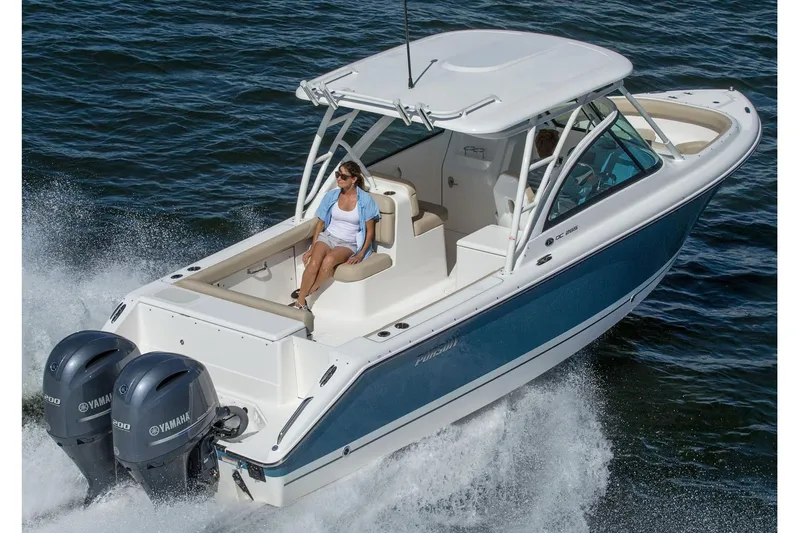Slide: The Image of Manufacturer Provided Image: 2016 Pursuit DC 265 Dual Console boat cruising on water. - 26