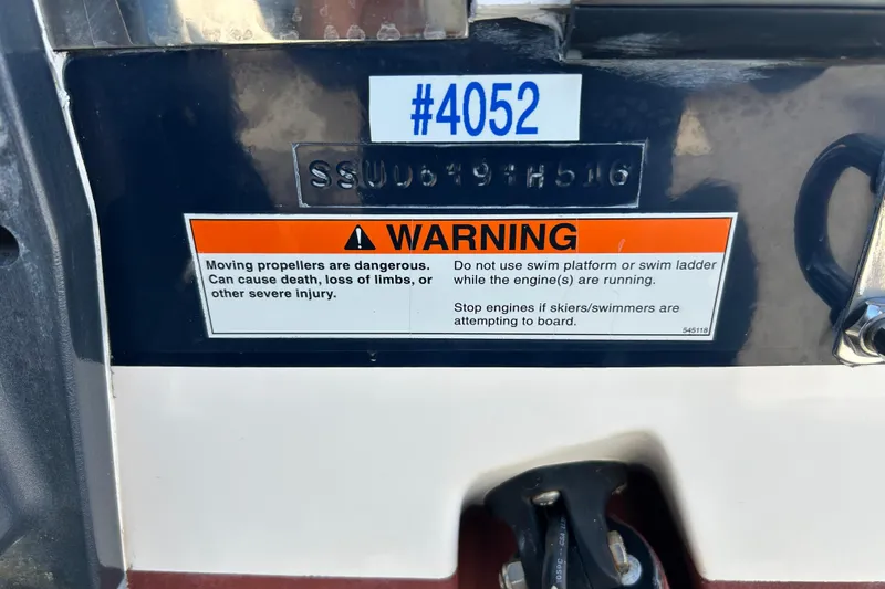 Slide: The Image of Warning label on 2016 Pursuit DC 265 Dual Console boat, cautioning about moving propellers. - 28