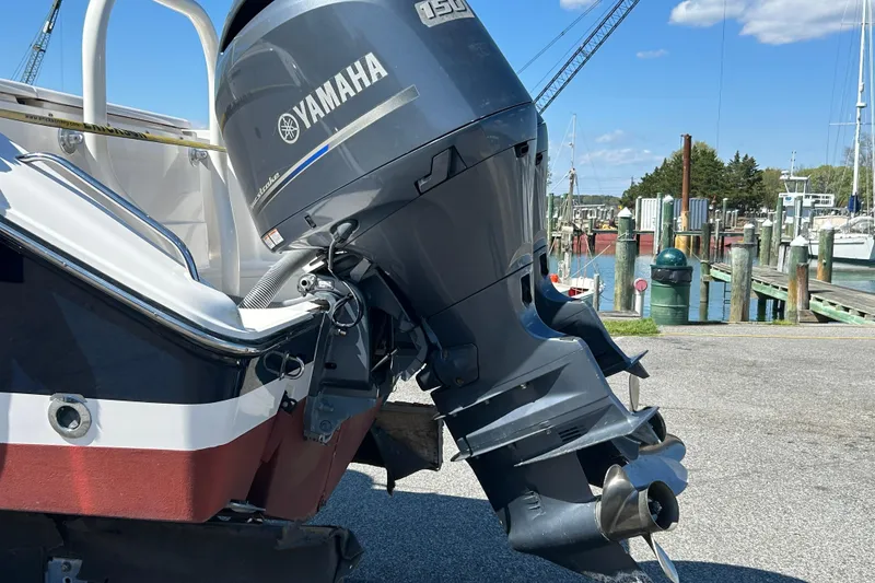 Slide: The Image of 2016 Pursuit DC 265 Dual Console with Yamaha outboard motor at marina. - 4