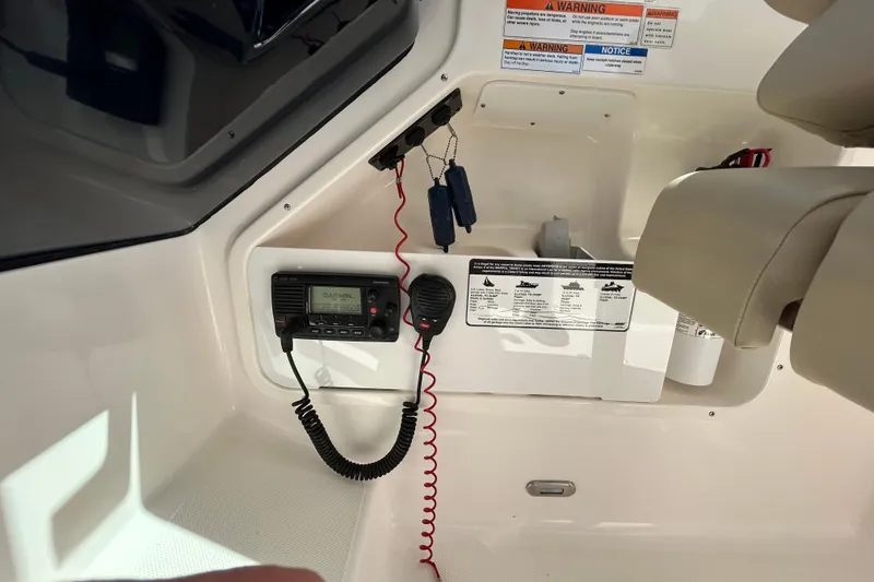 Slide: The Image of Interior of a 2016 Pursuit DC 265 Dual Console boat with Garmin radio equipment. - 8