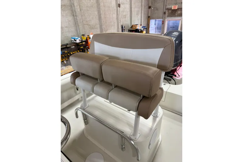 Slide: The Image of 2018 Parker 2100 SE boat seat with beige and white upholstery in a workshop setting. - 13