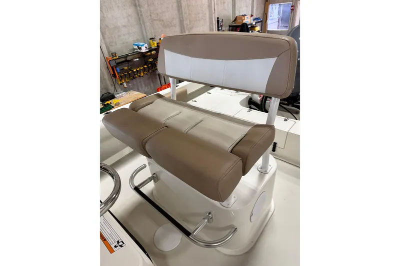 Slide: The Image of Brown and white cushioned boat seat on a 2018 Parker 2100 SE. - 14