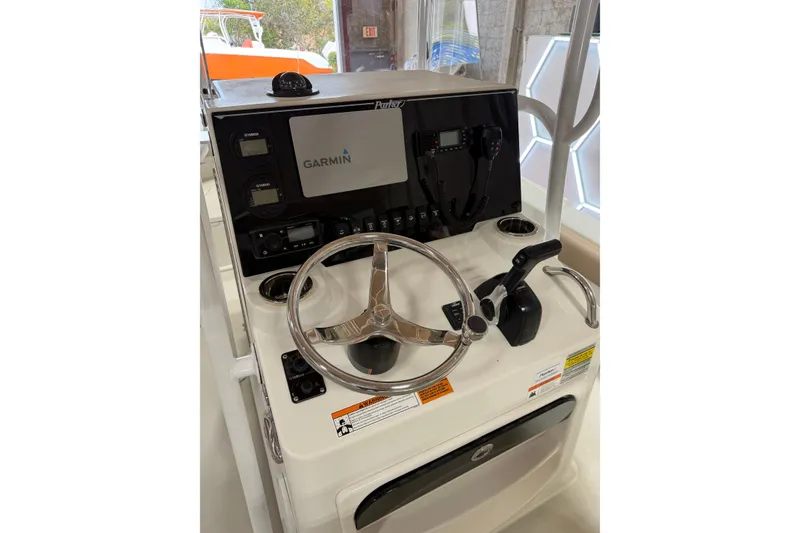 Slide: The Image of 2018 Parker 2100 SE boat console with Garmin navigation system and steering wheel. - 16