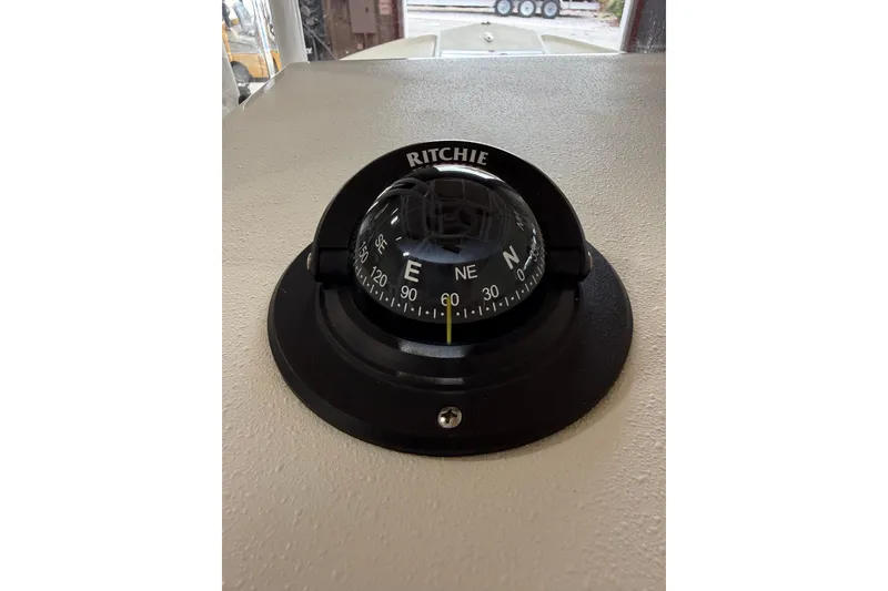 Slide: The Image of Ritchie compass on 2018 Parker 2100 SE boat dashboard, showing navigation directions. - 19