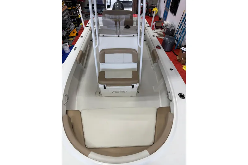 Slide: The Image of 2018 Parker 2100 SE boat interior with beige seating and white deck. - 22