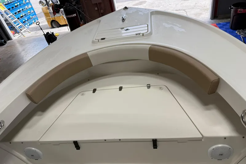 Slide: The Image of 2018 Parker 2100 SE boat interior with cushioned seating and storage compartment. - 24