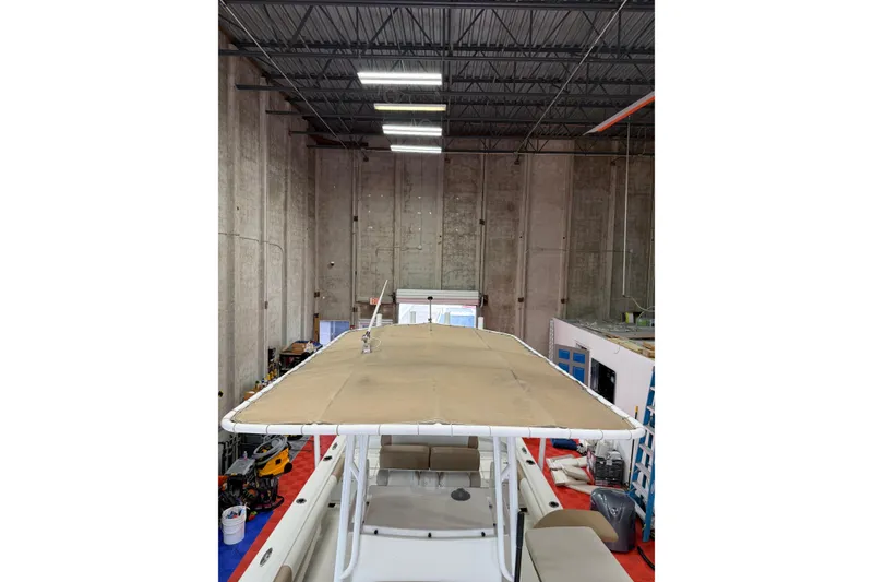 Slide: The Image of 2018 Parker 2100 SE boat in a warehouse with a beige canopy. - 26