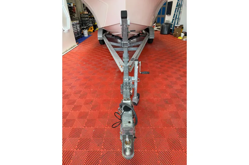 Slide: The Image of 2018 Parker 2100 SE boat on trailer in garage with red checkered floor. - 29