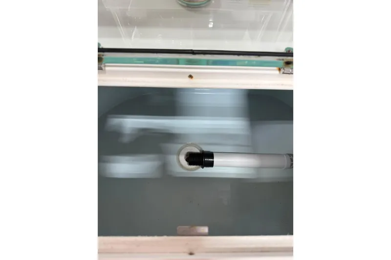 Slide: The Image of Livewell tank in a 2018 Parker 2100 SE boat, featuring a water inlet pipe. - 5