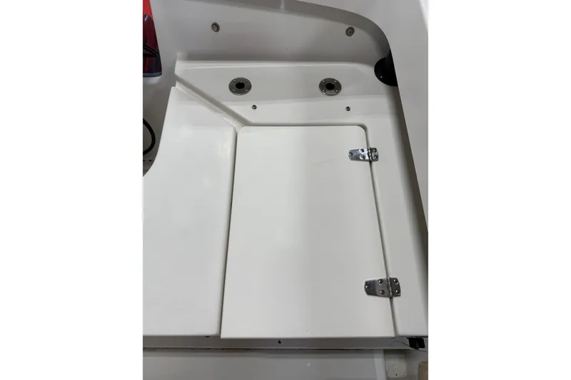 Slide: The Image of 2018 Parker 2100 SE boat storage compartment with white hinged door. - 6