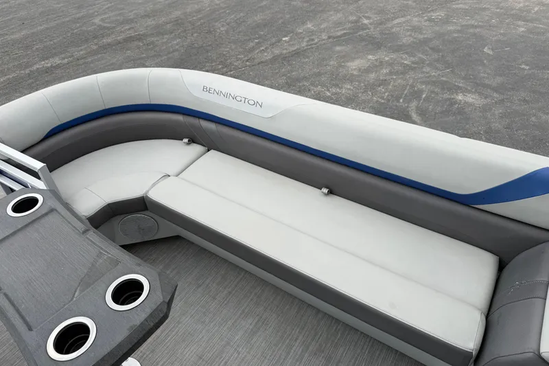 Slide: The Image of 2023 Bennington 25ssrc boat interior with gray seating and cup holders. - 22