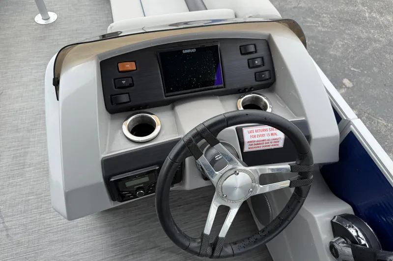 Slide: The Image of 2023 Bennington 25ssrc boat dashboard with steering wheel and control panel. - 24