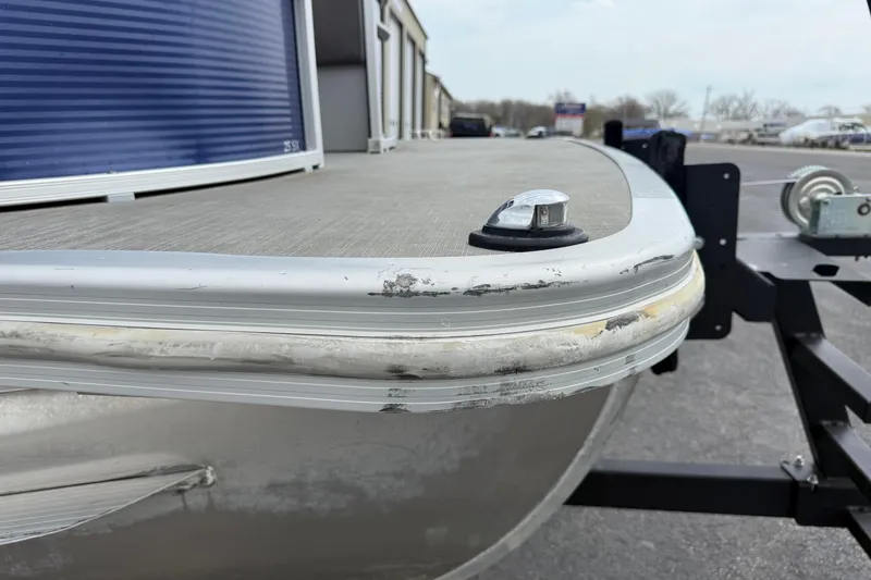 Slide: The Image of 2023 Bennington 25ssrc pontoon boat with visible wear on the bow edge. - 28